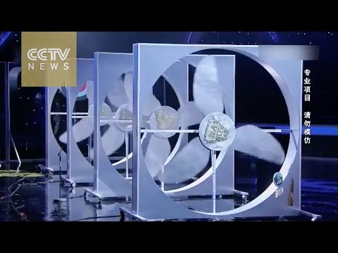 chinese girl shoots arrow through 4 revolving fans