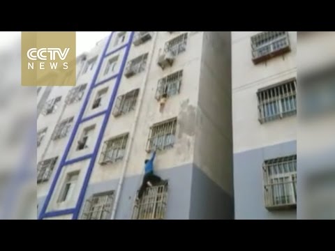 man climbs building with bare hands to save child hanging outside window